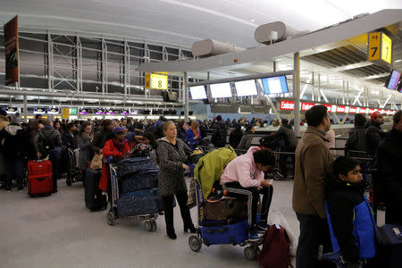 Passengers line up to check-in at the departures area of Terminal 4 at John F. Kennedy International Airport in New York City, U.S. January 7, 2018. REUTERS/Andrew Kelly