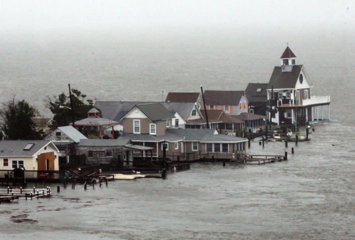 A row of houses stands in floodwaters at Grassy Sound in North Wildwood, N.J., as Hurricane Sandy pounds the East Coast Monday Oct. 29, 2012. The powerful storm made the westward lurch and took dead aim at New Jersey and Delaware on Monday, washing away part of the Atlantic City boardwalk, putting the presidential campaign on hold and threatening to cripple Wall Street and the New York subway system with an epic surge of seawater. (AP Photo/The Press of Atlantic City, Dale Gerhard) MANDATORY CREDIT