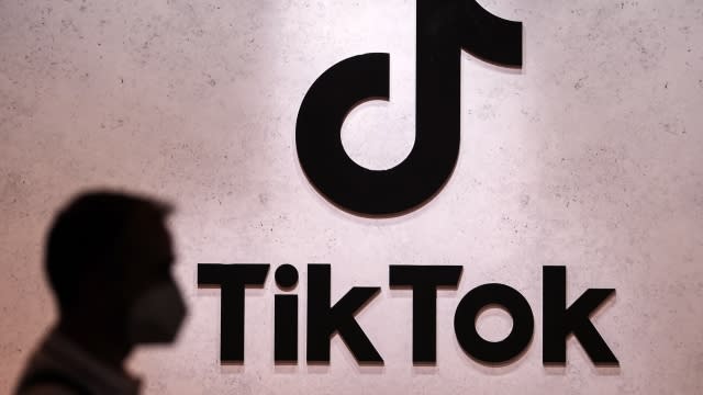 A visitor passes the TikTok exhibition