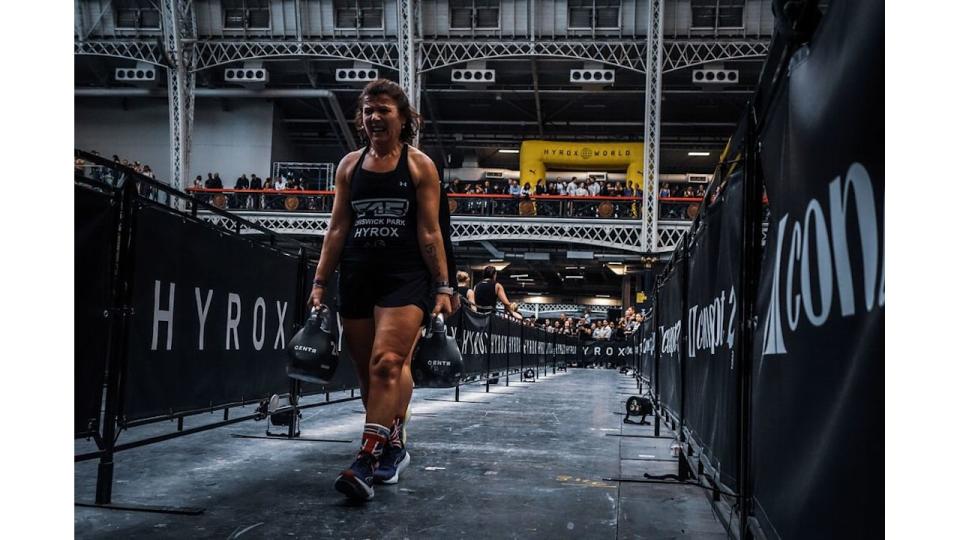 woman walking carrying heavy weights