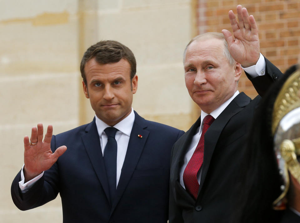 French President Emmanuel Macron, left, seen with Russian President Vladimir Putin in May, has criticized RT as a Russian propaganda outlet. (Photo: POOL New / Reuters)