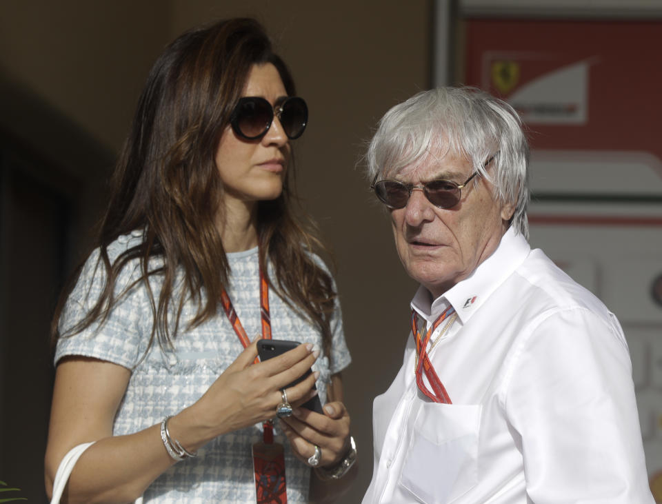 Formula One former boss Bernie Ecclestone, is flanked by his wife Fabiana Flosi, prior to the start of the Bahrain Formula One Grand Prix, at the Formula One Bahrain International Circuit in Sakhir, Bahrain, Sunday, April 16, 2017. (AP Photo/Luca Bruno)