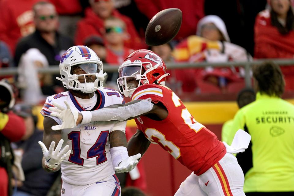 Buffalo Bills wide receiver Stefon Diggs (14) catches a touchdown pass as Kansas City Chiefs cornerback Joshua Williams (23) defends during the second half of an NFL football game Sunday, Oct. 16, 2022, in Kansas City, Mo. (AP Photo/Charlie Riedel)
