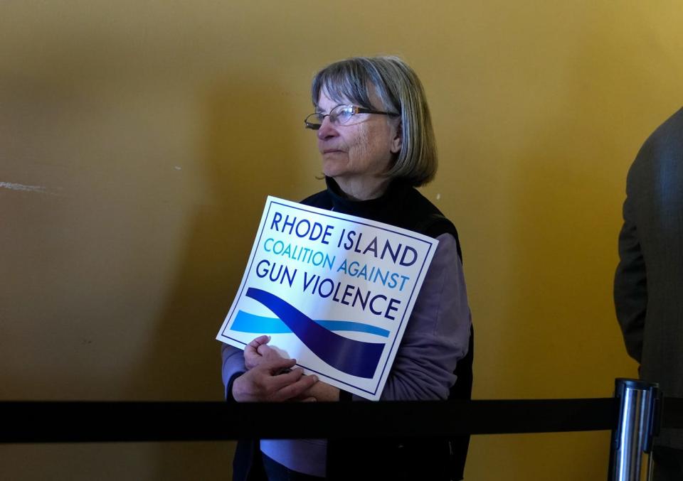 Gun opponent Susan Feeley of Providence waits in line with others to enter the Senate Judiciary hearings on a variety of gun bills at the State House last Tuesday.