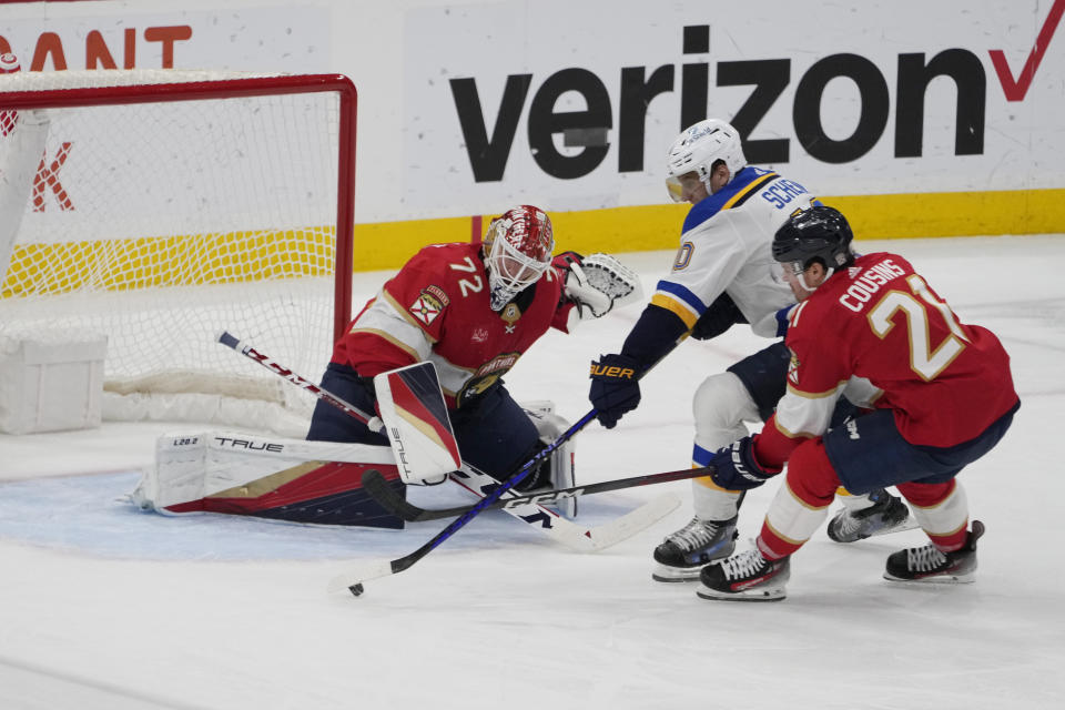 Florida Panthers goaltender Sergei Bobrovsky (72) and center Nick Cousins (21) defend St. Louis Blues center Brayden Schenn (10) during the second period of an NHL hockey game, Thursday, Dec. 21, 2023, in Sunrise, Fla. (AP Photo/Marta Lavandier)