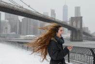 <p>Lenessa Age laughs as her hair is blown by a gust of wind in front of the Brooklyn Bridge during a winter storm in the Brooklyn borough of New York, Feb. 9, 2017. (Photo: Stephanie Keith/Reuters) </p>