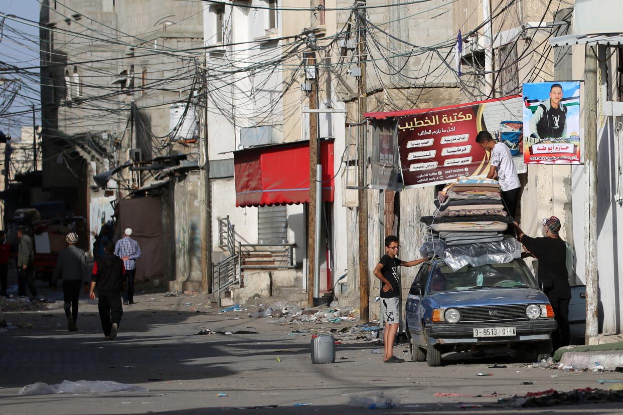 People gather their belonging as they prepare to flee Rafah in the southern Gaza Strip to a safer area (AFP via Getty Images)