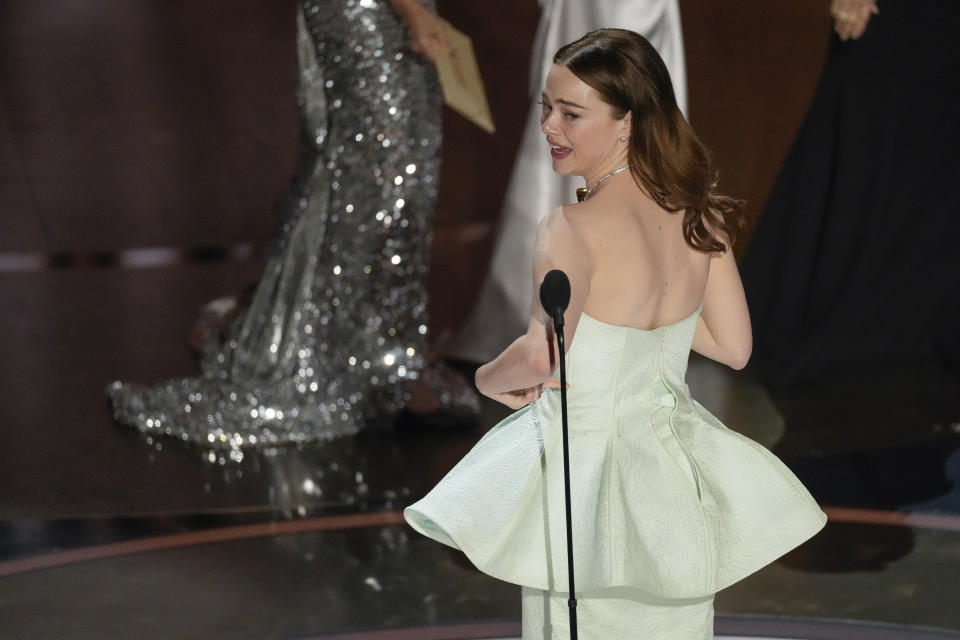 Emma Stone collects the award for Best Actress at the Dolby Theater in Los Angeles on Sunday.