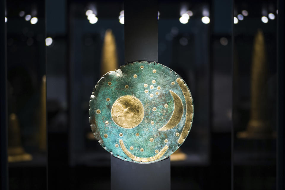 In this Sept. 20, 2018 photo the so-called Sky Disc of Nebra, made of bronze and gold, from 1,600 BC. is displayed at an archeological exhibition at the Martin-Gropius-Bau museum in Berlin. The new exhibition showcasing more than 1,000 major archaeological finds from the past 20 years shows reveals how Germany has been at the heart of European trade, migration, conflict and innovation since the Stone Age. The exhibition runs from Sept. 21, 2018 until Jan. 6, 2019. (AP Photo/Markus Schreiber)