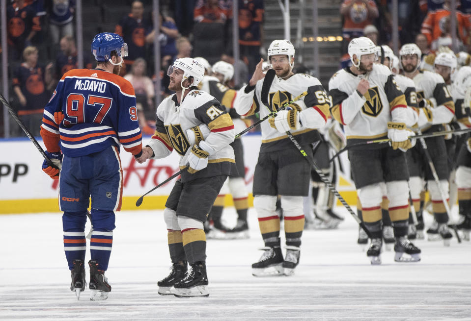 Vegas Golden Knights' Jonathan Marchessault (81) and Edmonton Oilers' Connor McDavid (97) shake hands after Game 6 of an NHL Stanley Cup second-round playoff hockey series in Edmonton, Alberta, Sunday, May 14, 2023. (Jason Franson/The Canadian Press via AP)
