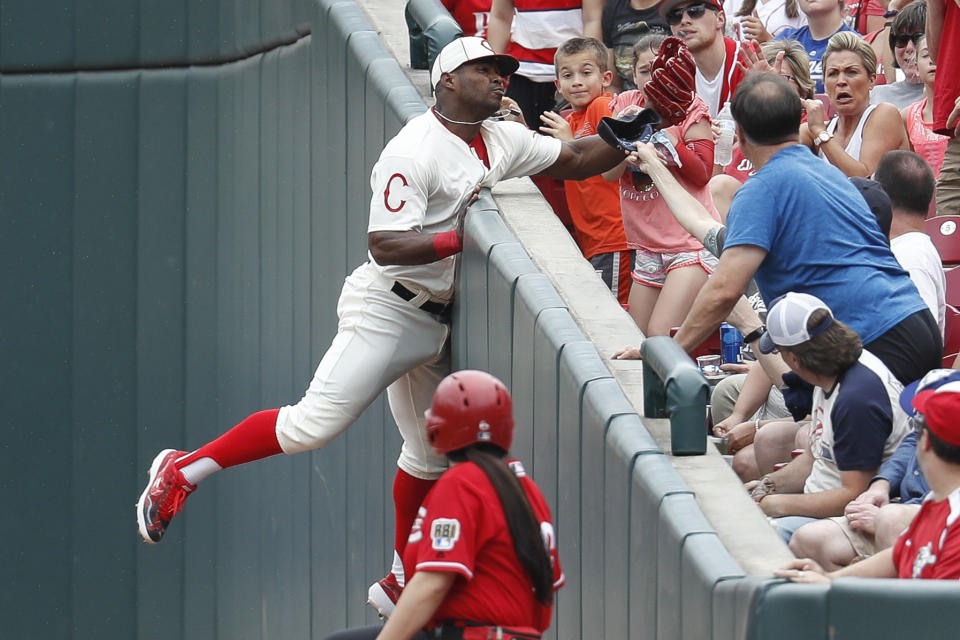 Cincinnati Reds' Yasiel Puig catches a foul ball hit by Los Angeles Dodgers' Hyun-Jin Ryu in the sixth inning of a baseball game, Sunday, May 19, 2019, in Cincinnati. (AP Photo/John Minchillo)