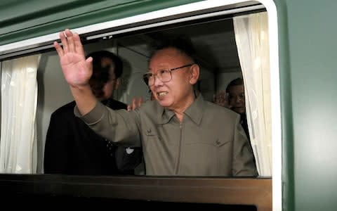 Kim Jong-il waving from a train while leaving Beijing in May 2010 - Credit:  KNS/AFP/Getty Images