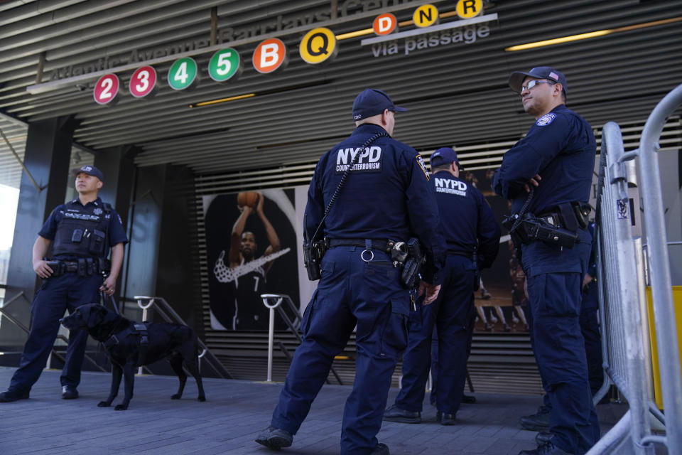 Police officers patrol a subway station in New York, Tuesday, April 12, 2022. Multiple people were shot and injured Tuesday at a subway station in New York City during a morning rush hour attack that left wounded commuters bleeding on a train platform. (AP Photo/Seth Wenig)