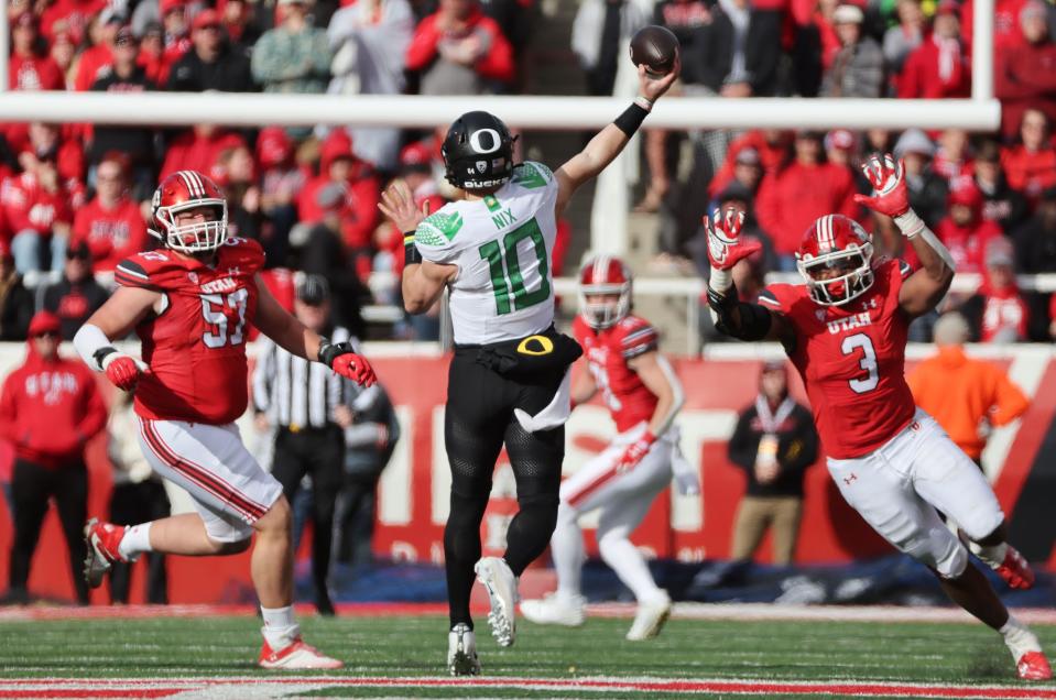 Utah Utes defensive tackle Keanu Tanuvasa (57) and Utah Utes linebacker Levani Damuni (3) hurry Oregon Ducks quarterback Bo Nix (10) in Salt Lake City on Saturday, Oct. 28, 2023. Oregon won 35-6. | Jeffrey D. Allred, Deseret News