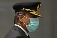 A pilot wearing a mask arrives at the international lounge at Pearson Airport in Toronto