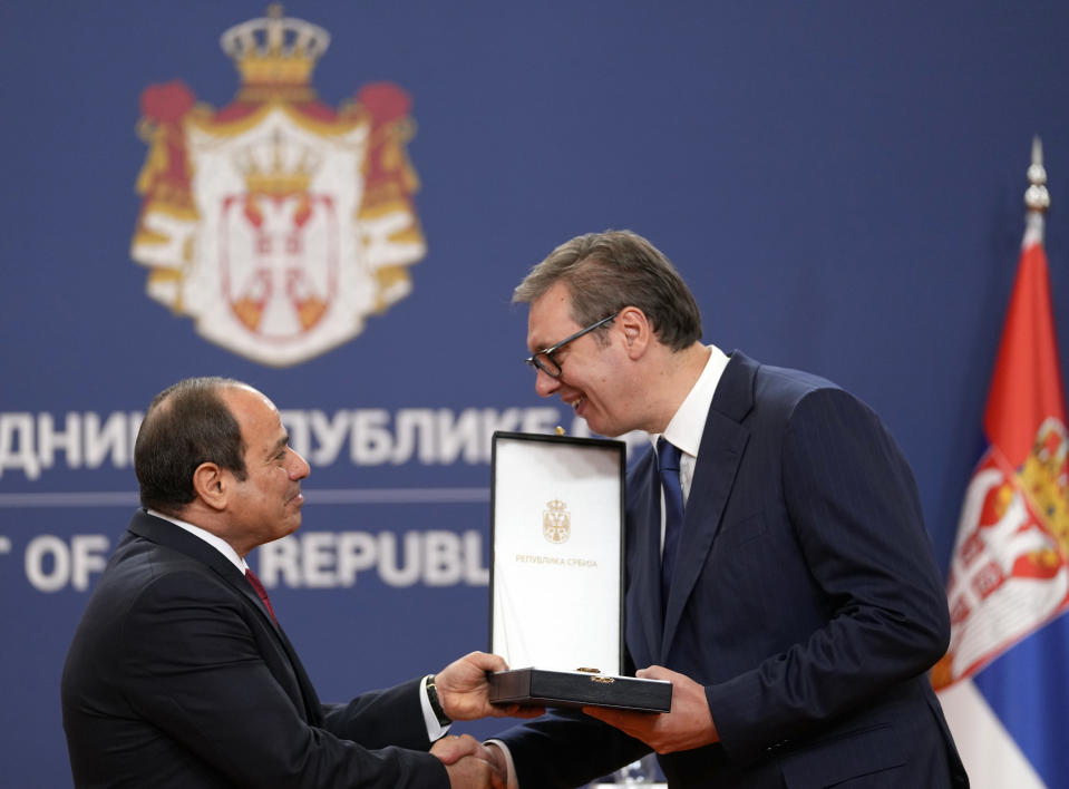 Egyptian President Abdel Fattah el-Sisi, left, receives the Order of Serbia with a ribbon from his Serbian counterpart Aleksandar Vucic at the Serbia Palace in Belgrade, Serbia, Wednesday, July 20, 2022. Abdel Fattah el-Sisi is on a three-day official visit to Serbia. (AP Photo/Darko Vojinovic)