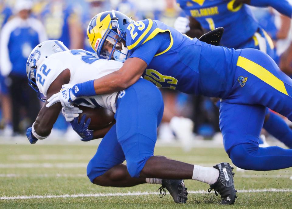 Delaware defensive back Noah Plack brings down Hampton's Darran Butts in the first quarter at Delaware Stadium, Saturday, Sept. 24, 2022.