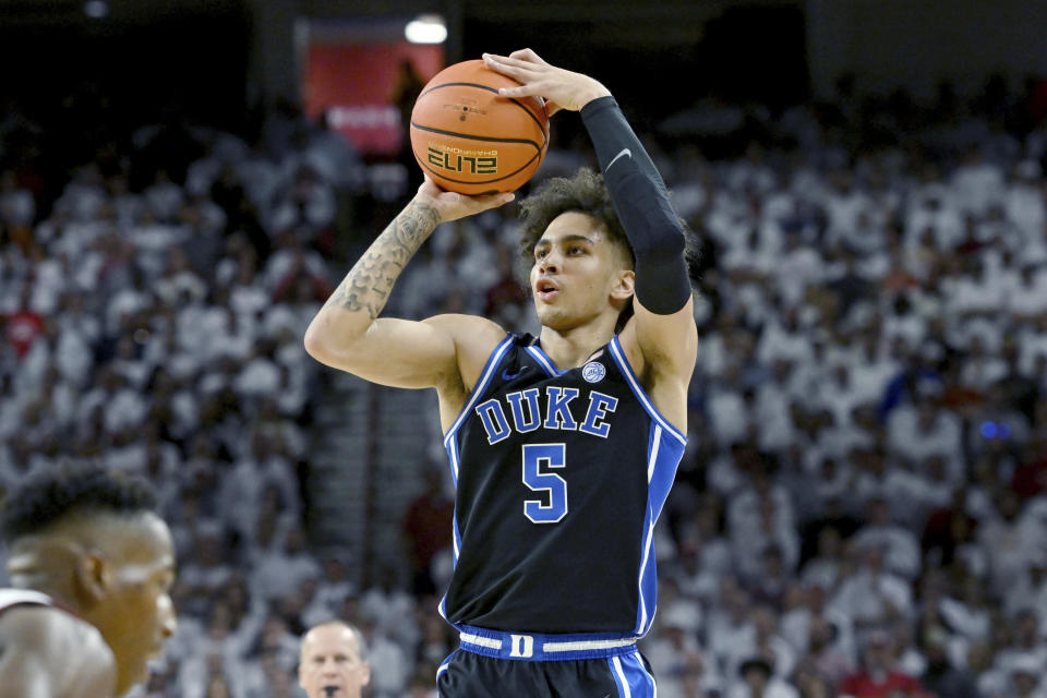 Duke guard Tyrese Proctor (5) shoots over an Arkansas defender during the first half of an NCAA college basketball game Wednesday, Nov. 29, 2023, in Fayetteville, Ark. (AP Photo/Michael Woods)