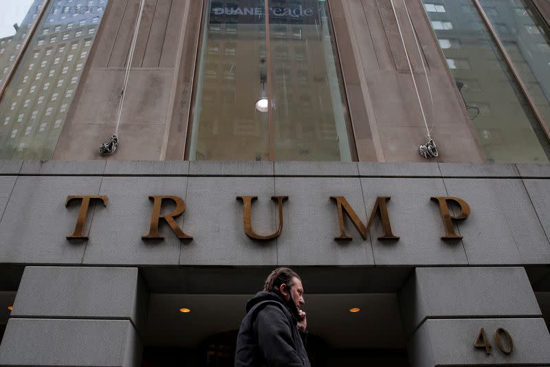 FILE PHOTO: A woman walks past 40 Wall Street, also known as the Trump Building, in the Manhattan borough of New York