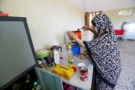 Tabra al-Hamali, a Libyan displaced woman, prepares meals in a school used as a shelter at Abu Slim district in Tripoli