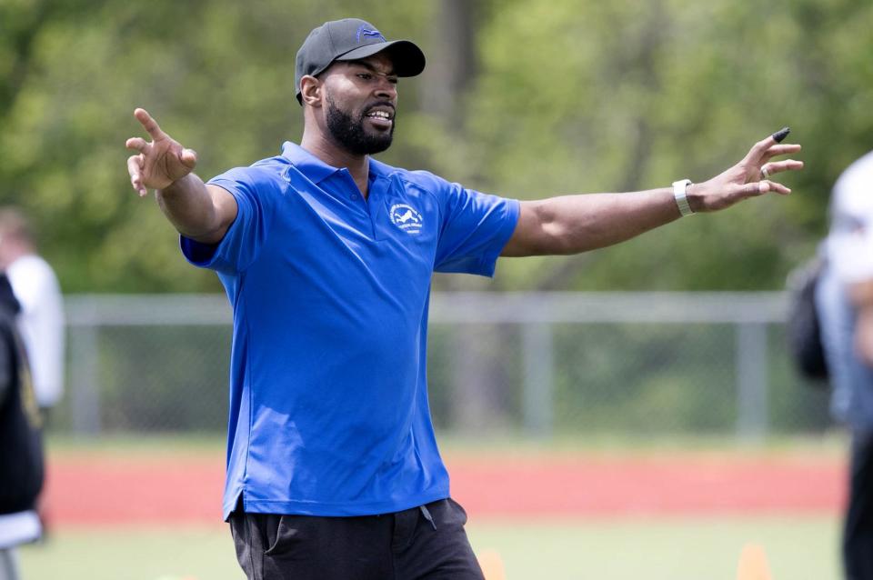 Former Detroit Lions receiver Calvin Johnson works with young players during the Calvin Johnson Jr. Foundation Catch a Dream football camp held at Southfield high school Saturday, May 20, 2017 in Southfield.