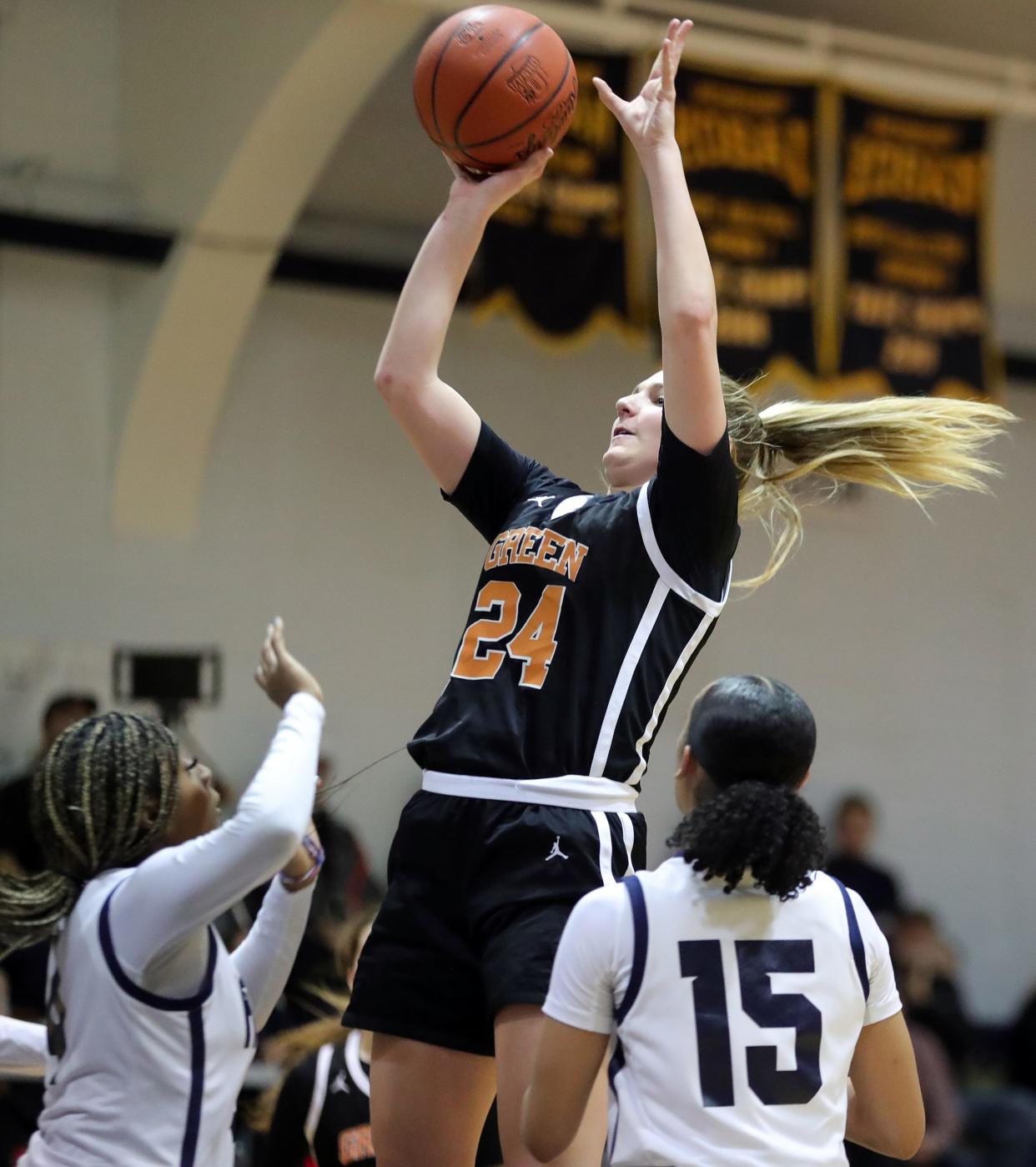 Green's Jenna Slates puts up a shot over a pair of Hoban defenders during the first half of a high school basketball game, Wednesday, Feb. 7, 2024, in Akron, Ohio.