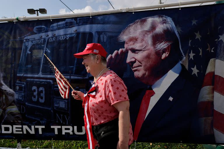 Seguidores del expresidente de Estados Unidos Donald Trump esperan la caravana que le llevará al aeropuerto internacional de Palm Beach el 3 de abril de 2023 en West Palm Beach, Florida.