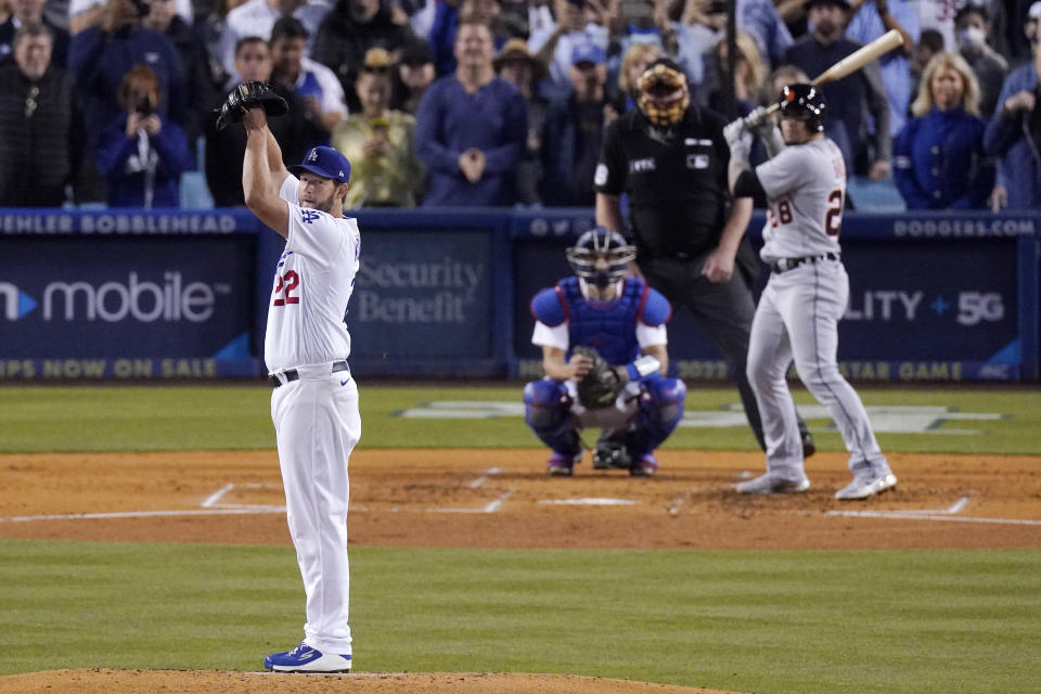 Los Angeles Dodgers starting pitcher Clayton Kershaw, left, checks second before pitching to Detroit Tigers' Javier Baez, right, as catcher Austin Barnes, second from left, and home plate umpire Bill Miller watch during the third inning of a baseball game Saturday, April 30, 2022, in Los Angeles. (AP Photo/Mark J. Terrill)