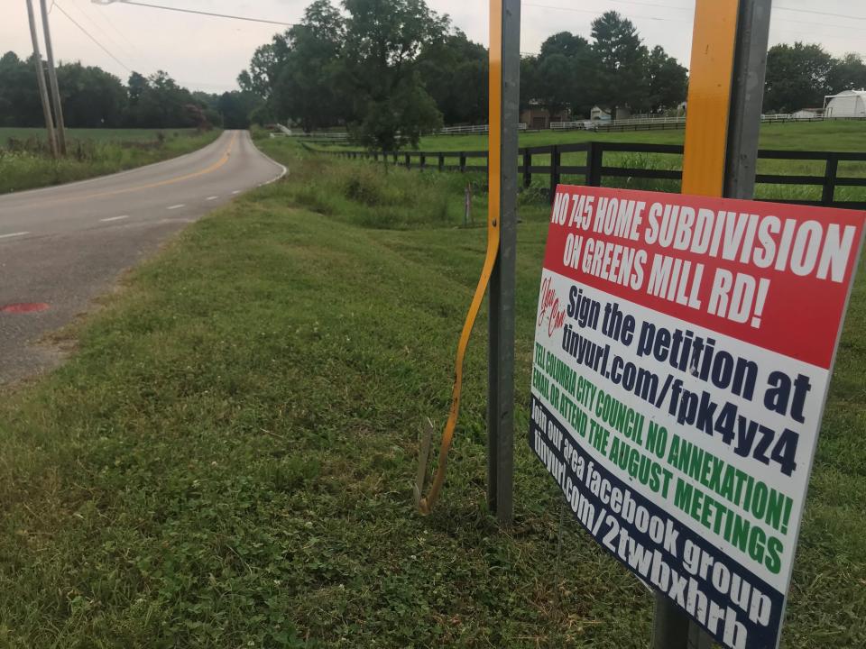 Dozens of residents on Greens Mill Road have displayed signs opposing a proposal for a 700-home residential development that they say would ruin the pastoral landscape and increase traffic.