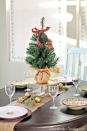 <p>Go all out for a holiday table centerpiece, and place a miniature evergreen — topped with a ribbon — in the middle of your spread.</p><p>See more at <a href="http://www.domestically-speaking.com/2013/12/christmas-home-tour-2013.html" rel="nofollow noopener" target="_blank" data-ylk="slk:Domestically Speaking;elm:context_link;itc:0;sec:content-canvas" class="link ">Domestically Speaking</a>. </p>