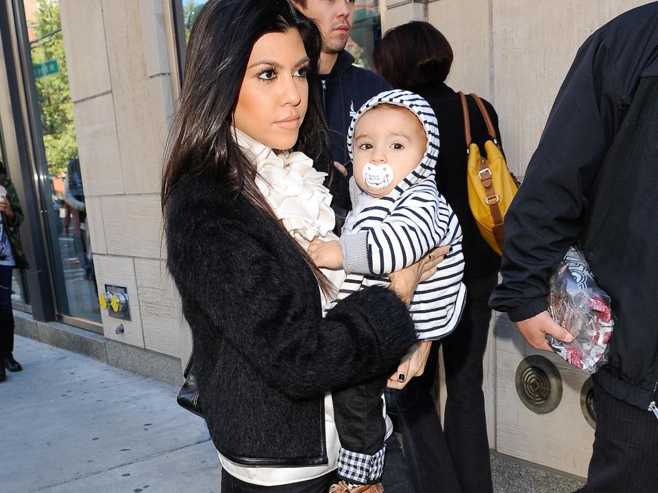 Kourtney Kardashian totes son Mason Disick around New York City in 2010.
