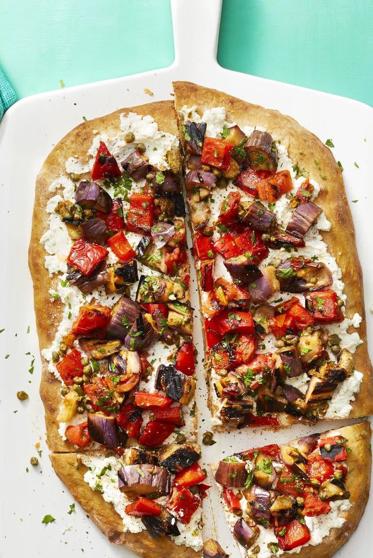 <p>This flatbread is the sweet-and-sour pizza of your dreams. Eggplant, peppers, honey, and ricotta are just a few of the tasty aspects of your new favorite flatbread.<em><br></em></p><p><em>Get the <a href="https://www.womansday.com/food-recipes/food-drinks/a22482763/caponata-flatbread-recipe/" rel="nofollow noopener" target="_blank" data-ylk="slk:Caponata Flatbread recipe;elm:context_link;itc:0;sec:content-canvas" class="link ">Caponata Flatbread recipe</a>.</em></p>