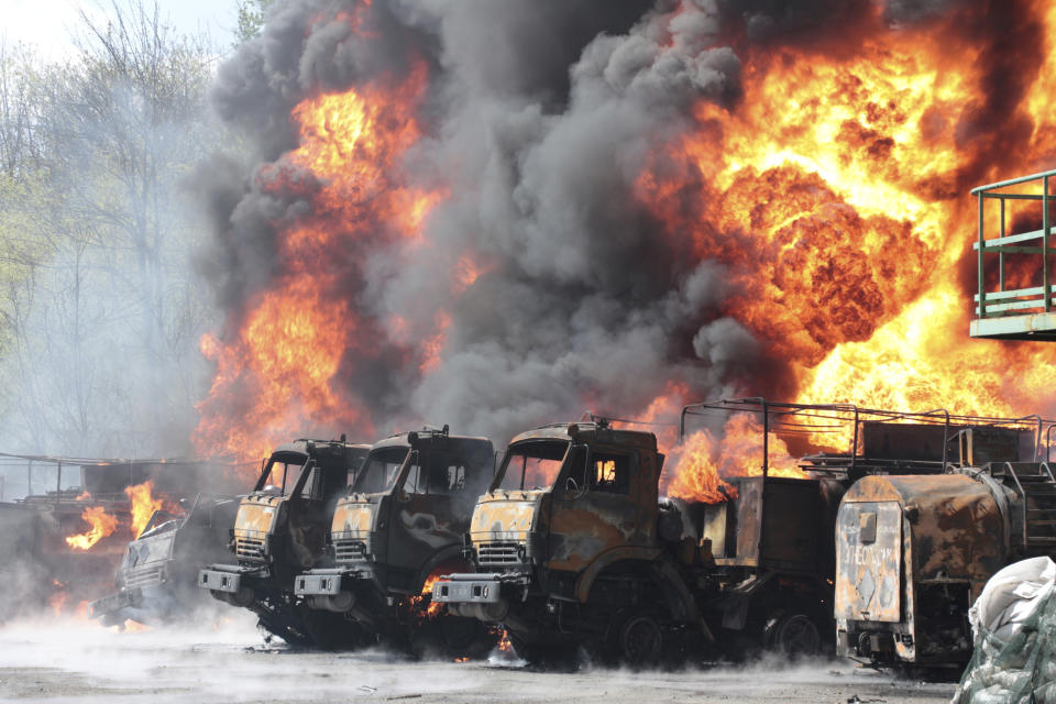 Vehicles are on fire at an oil depot after missiles struck the facility in an area controlled by Russian-backed separatist forces in Makiivka, east of Donetsk, eastern Ukraine, Wednesday, May 4, 2022. (AP Photo)