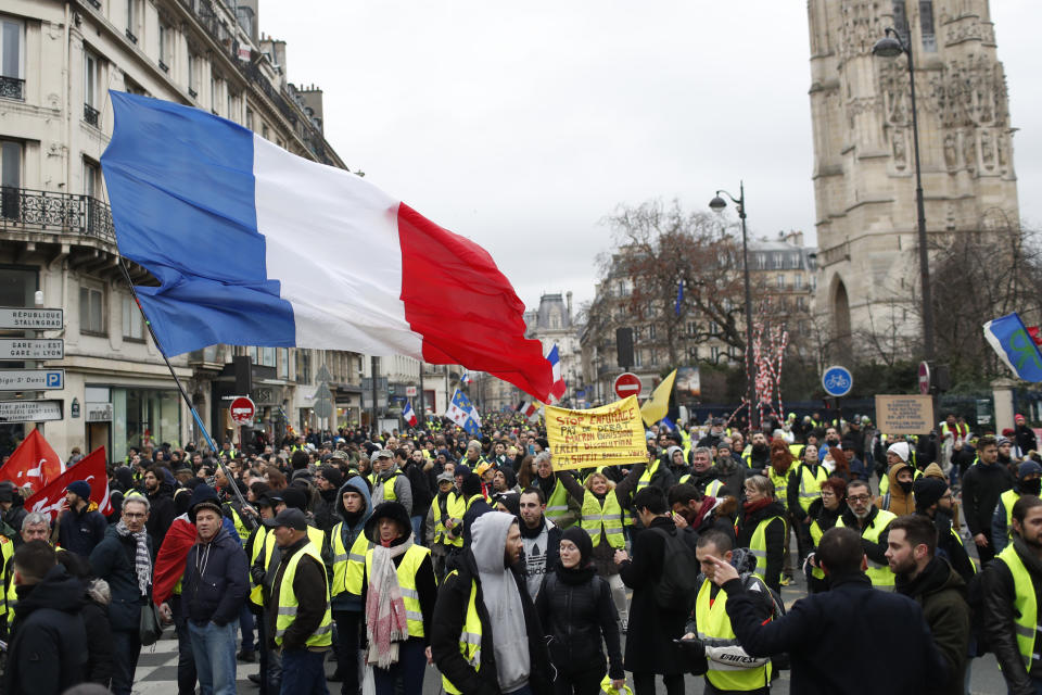 Yellow vest protesters demonstrate peacefully in the streets of Paris, France, Saturday, Jan. 12, 2019. Authorities deployed 80,000 security forces nationwide for a ninth straight weekend of anti-government protests. (AP Photo/Thibault Camus)