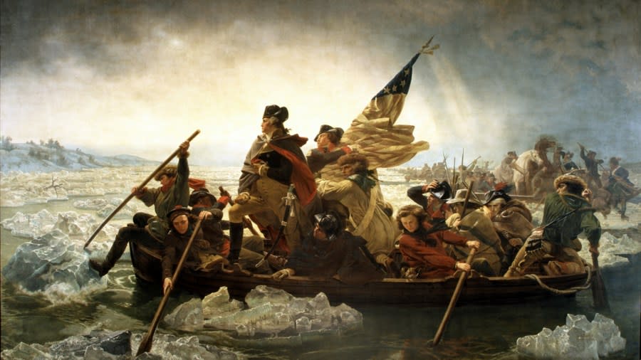 The painting shows General George Washington standing tall, looking across the river while his crew paddles them across, with one man steering and another using a tool to move pieces of ice out of their way.