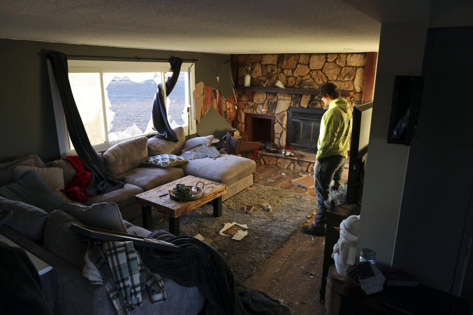 Patrick Crull tours the damage inside his home along North Tolles Road, Friday morning, Feb. 9, 2024, after a confirmed tornado went through the area just northwest of Evansville, Wis., the prior evening. Crull and his girlfriend moved into the house last December after several months of remodeling the interior. The tornado was the first-ever reported in February in the state of Wisconsin, according to the National Weather Service. (Anthony Wahl//The Janesville Gazette via AP)