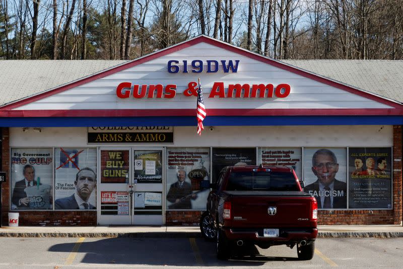 FILE PHOTO: Signs cover the front of the 619DW Guns and Ammo store in Merrimack