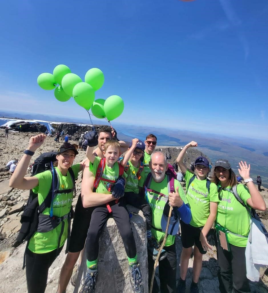 Group of people on op of a mountain 