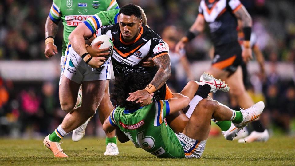 Former Wests Tigers player Aitasi James (centre).