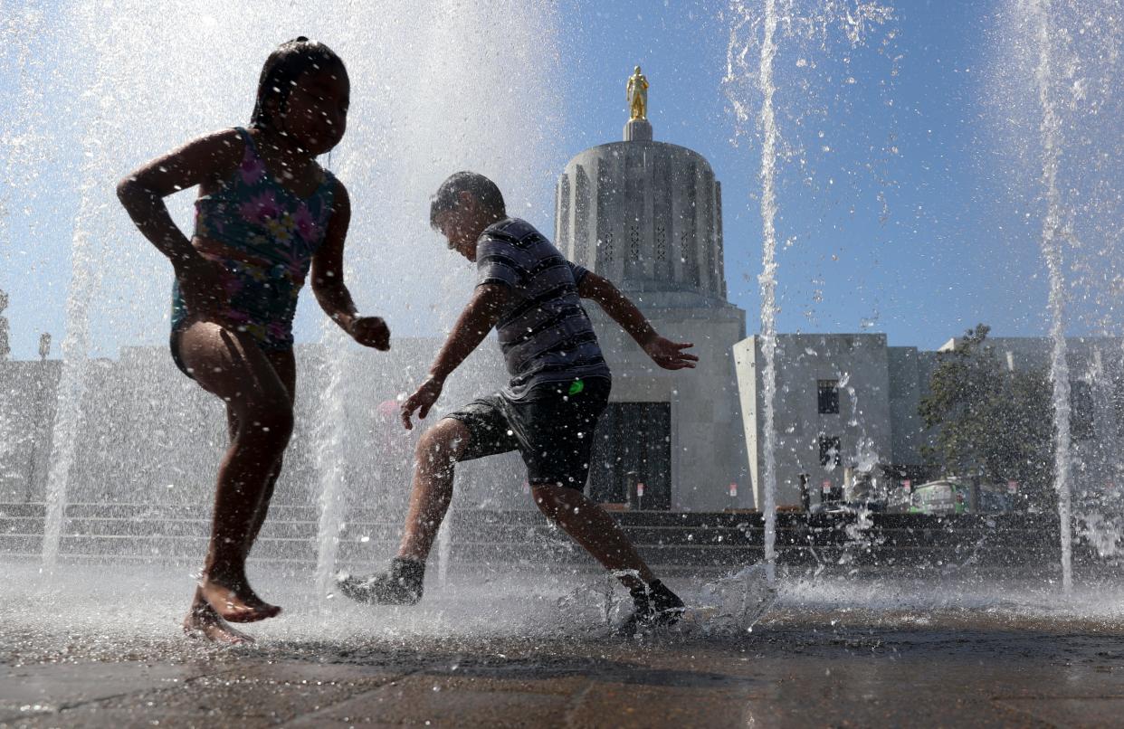 Oregon saw its 10th hottest year in recorded history in 2022. Seen here, children play in the splash fountain at the Capitol Mall in Salem at the State Capitol.