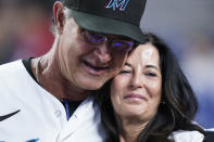 Miami Marlins manager Don Mattingly hugs his wife Lori Mattingly as he is recognized on the field during the fifth inning of a baseball game against the Atlanta Braves, Wednesday, Oct. 5, 2022, in Miami. (AP Photo/Wilfredo Lee)