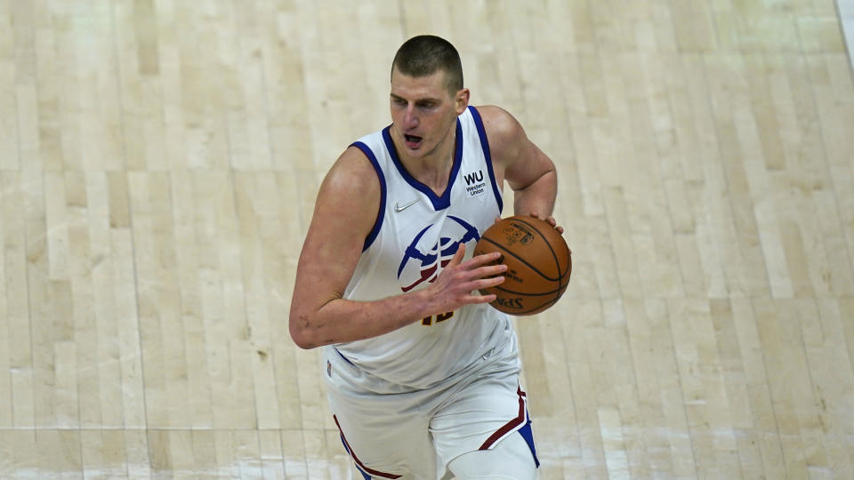 Denver Nuggets center Nikola Jokic (15) brings the ball up court in the second half during an NBA basketball game against the Utah Jazz Friday, May 7, 2021, in Salt Lake City. (AP Photo/Rick Bowmer)