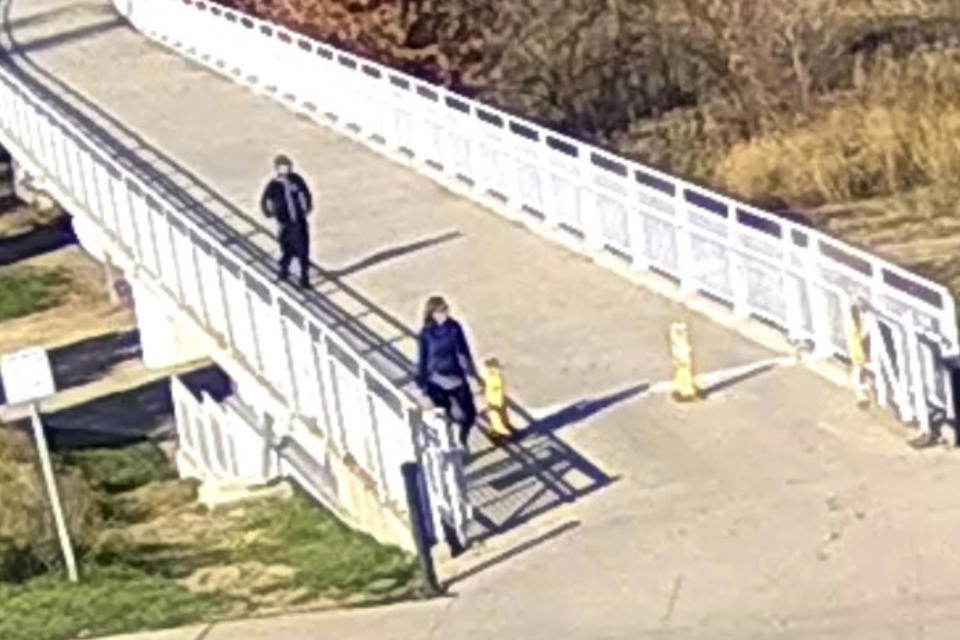 In this surveillance camera image released by the Council Bluffs, Iowa, Police Department, former U.S. Sen. Martha McSally of Arizona, is followed by a man while she was jogging at Tom Hanafan River’s Edge Park, Wednesday, Nov. 8, 2023, in Council Bluffs, Iowa. A man was arrested early Friday, Nov. 10, in the alleged assault of McSally, who says she was molested as she jogged along the Missouri River in Council Bluffs. (Council Bluffs Police Department via AP)