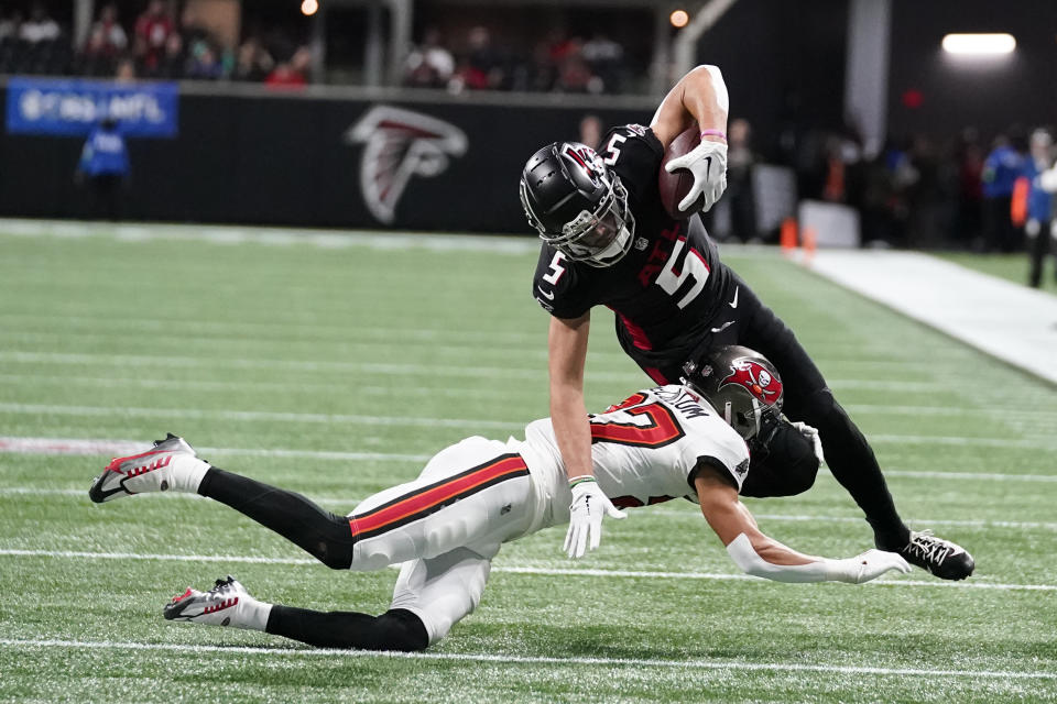 Atlanta Falcons wide receiver Drake London (5) is stopped by Tampa Bay Buccaneers cornerback Zyon McCollum (27) after making a catch during the first half of an NFL football game, Sunday, Dec. 10, 2023, in Atlanta. (AP Photo/Brynn Anderson)