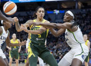 Minnesota Lynx center Sylvia Fowles (34) battles for the ball with Seattle Storm forward Gabby Williams (5) during the second quarter of a WNBA basketball game Friday, Aug. 12, 2022, in Minneapolis. (Elizabeth Flores/Star Tribune via AP)