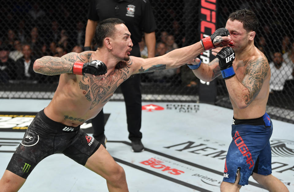 EDMONTON, ALBERTA - JULY 27:   (L-R) Max Holloway punches Frankie Edgar in their UFC featherweight championship bout during the UFC 240 event at Rogers Place on July 27, 2019 in Edmonton, Alberta, Canada. (Photo by Jeff Bottari/Zuffa LLC/Zuffa LLC)