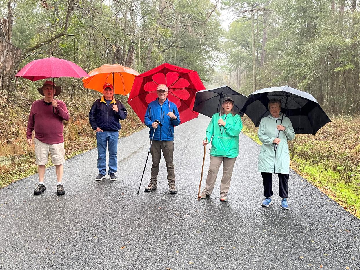 OLLI Walking Club members hike on a rainy day. Registration is open for summer classes, which start May 6, 2024.
