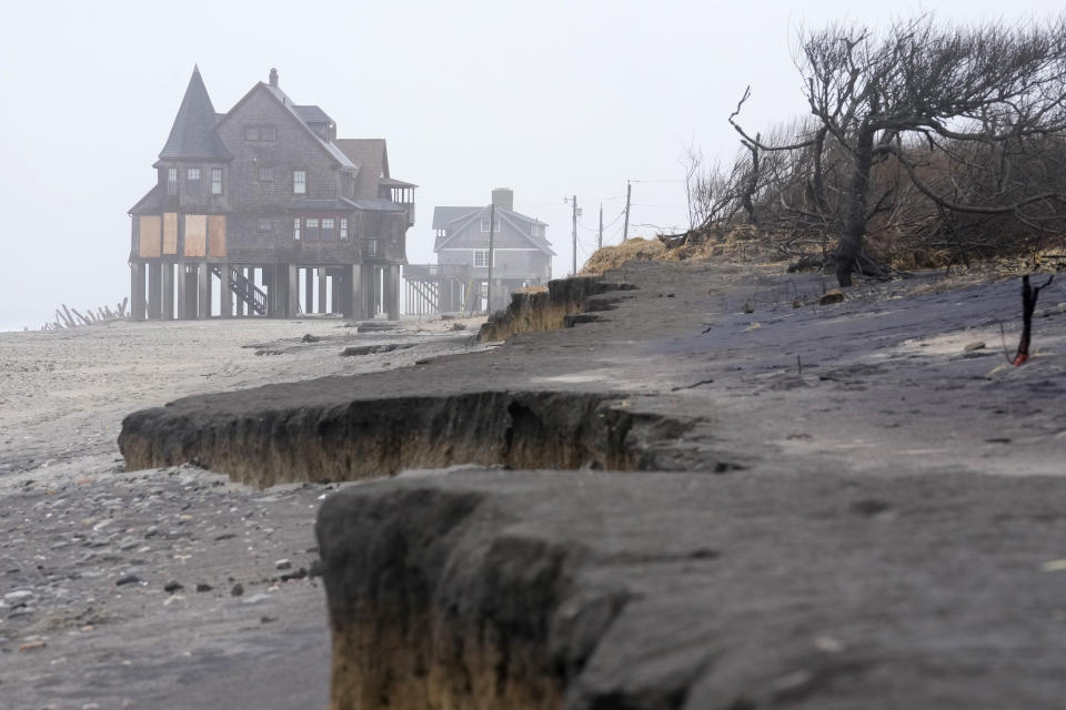 Houses resting on pylons are elevated above the beach, Thursday, Jan. 25, 2024, in South Kingstown, R.I. Experts say erosion and receding shorelines are becoming more common due to ocean rise and climate change. (AP Photo/Steven Senne)