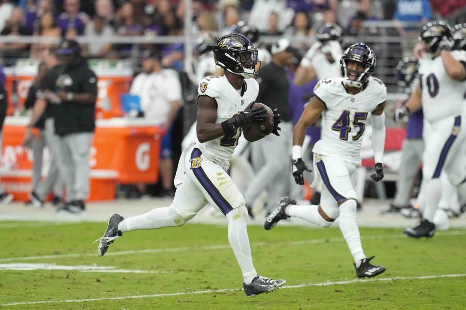 Baltimore Ravens safety DeAndre Houston-Carson (45) celebrates an interception by cornerback Brandon Stephens (21) during the first half of an NFL football game against the Arizona Cardinals Sunday, Oct. 29, 2023, in Glendale, Ariz. (AP Photo/Ross D. Franklin)