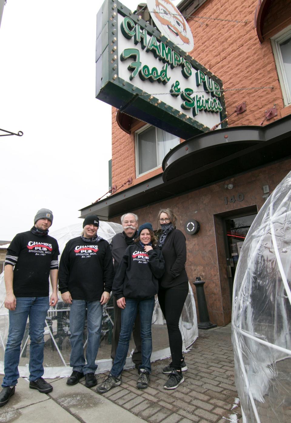 Staff at Champ’s Pub in Brighton, from left, former cook Sean Wilson and current cook Scott Claxtonsteine, owner Dave “Champ” Beauchamp, server Chelsea Hamilton and bartender Kerri Sauve, are shown Friday, Jan. 22, 2021, when they were preparing to reopen indoor dining.